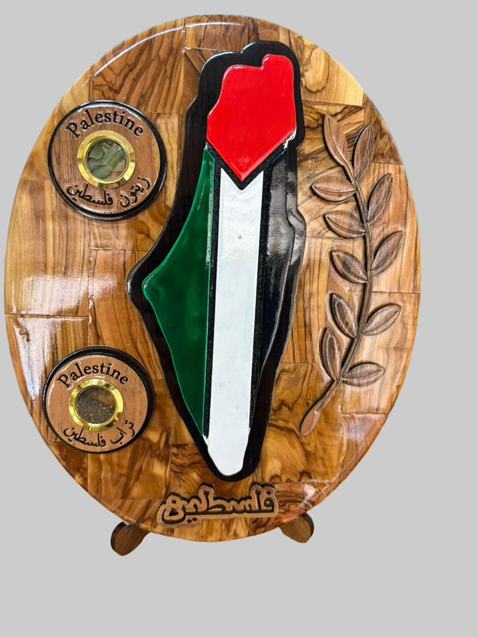Wooden plaque with a red, green, and white design on a wooden surface