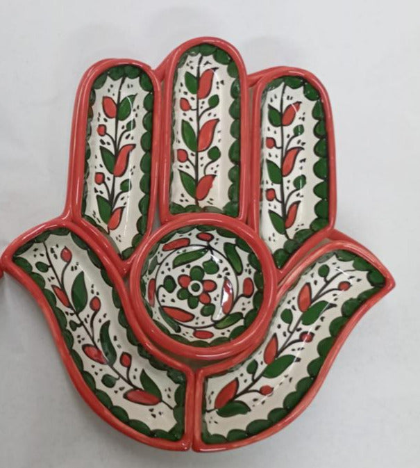 Decorative hamsa hand with intricate patterns on a white background