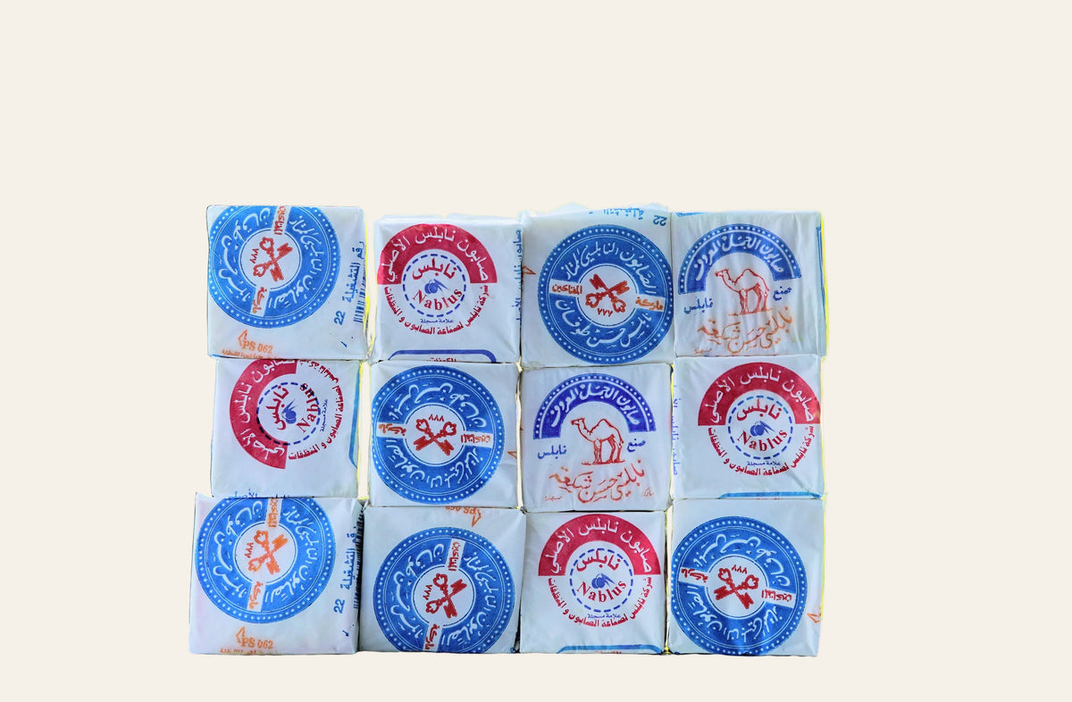 Stack of soap bars with colorful labels against a blurred natural background